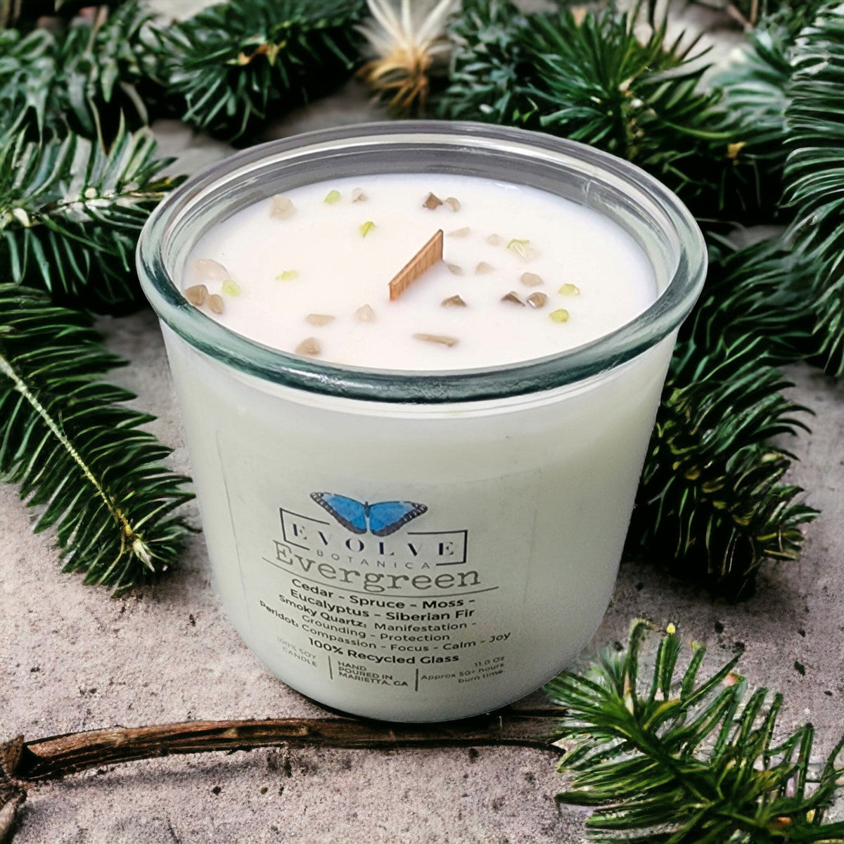 Evergreen Rocks Candle by Evolve Botanica featuring wood wick, peridot and smoky quartz gemstones, soy wax, and natural design.
