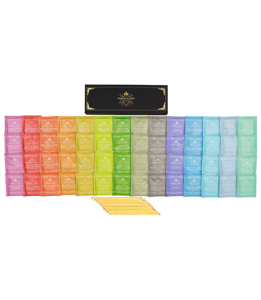 Open gift set of Harney & Sons Fine Teas teabags and honey sampler in a box with assorted tea bags and honey jars inside.