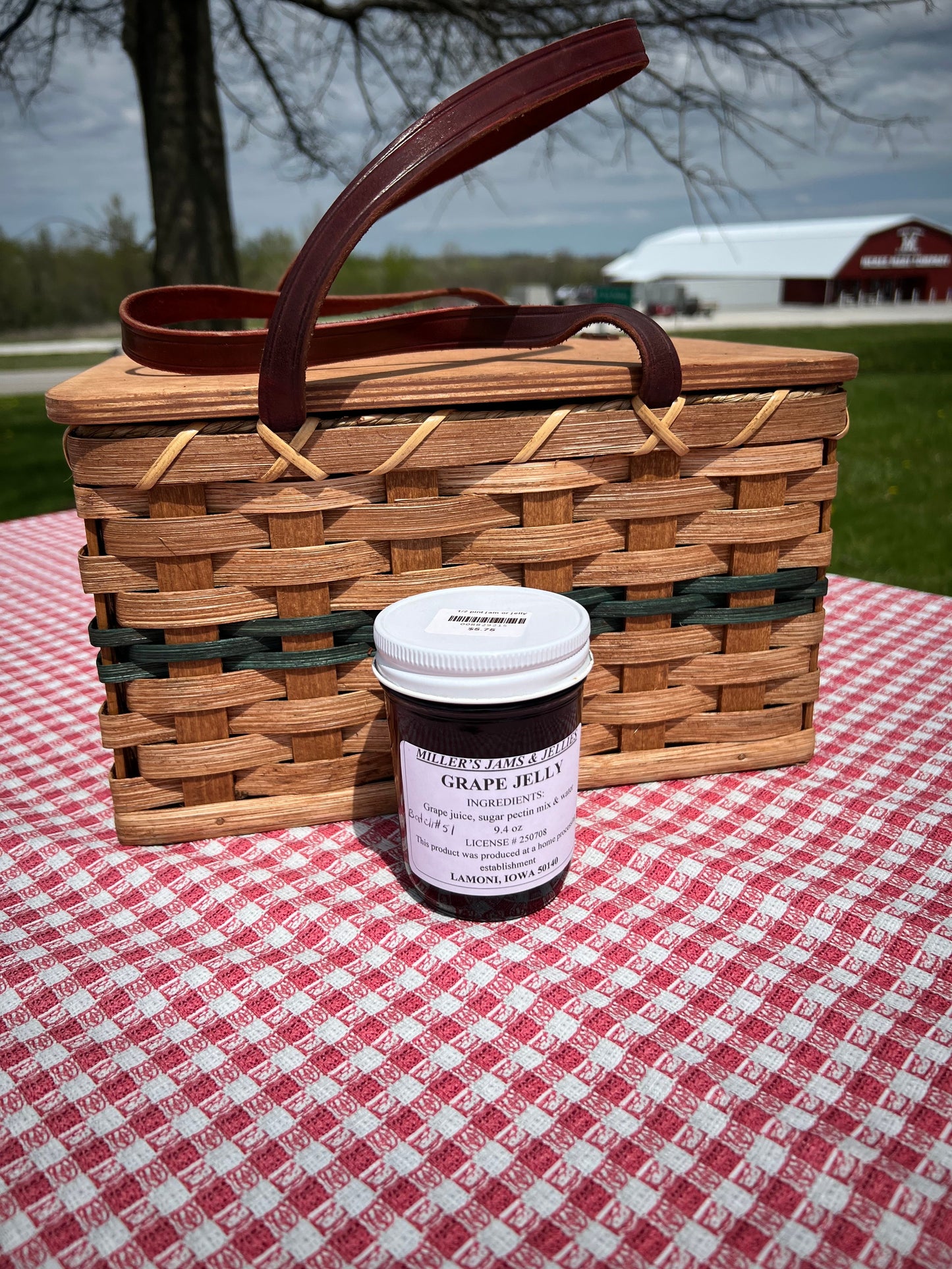 Amish Country Store Miller’s Grape Jelly jar showing purple grape jelly with a white lid on a wooden surface.