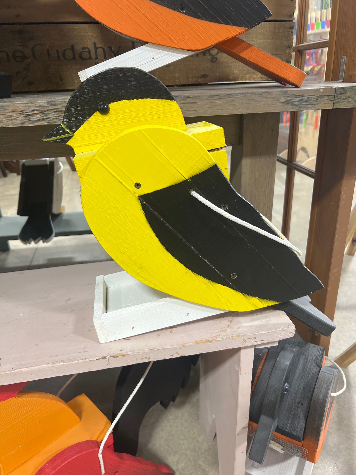 Amish-made wooden bird feeder in bird shape, handcrafted garden decor, showcasing detailed natural wood and multiple styles.