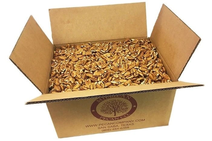 Millican Pecan fresh shelled raw pecan halves, natural light, close-up view, showing their golden-brown color and crunchy texture.