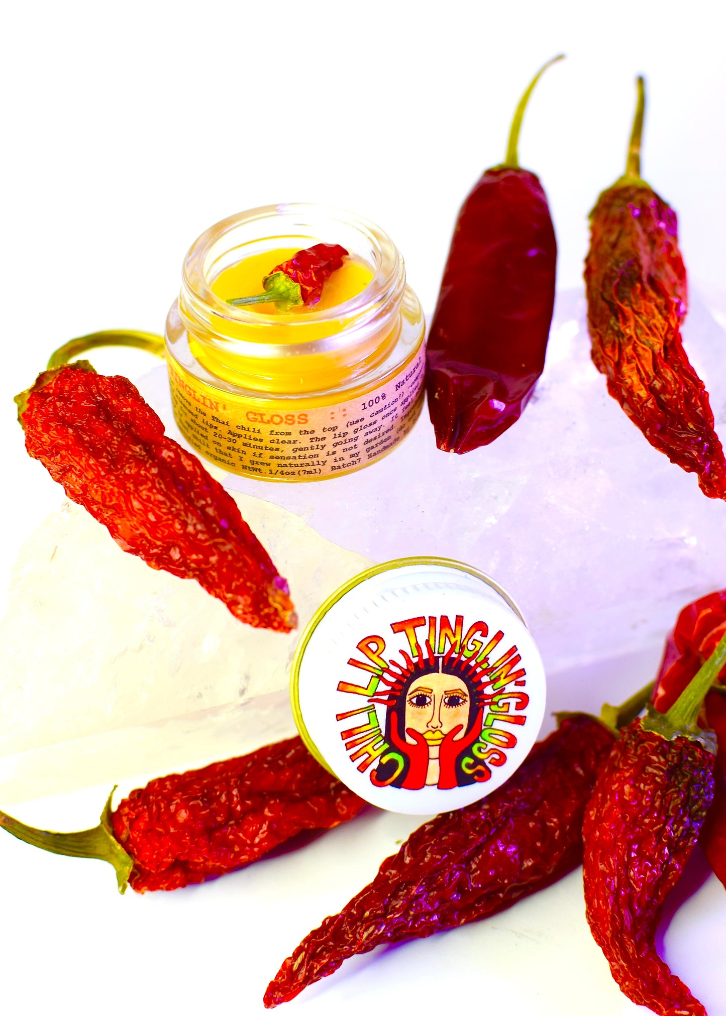 Plant Makeup Chili Lip Tinglin' Gloss featuring a shiny, tinted lip gloss with a tingling sensation in a sleek tube.