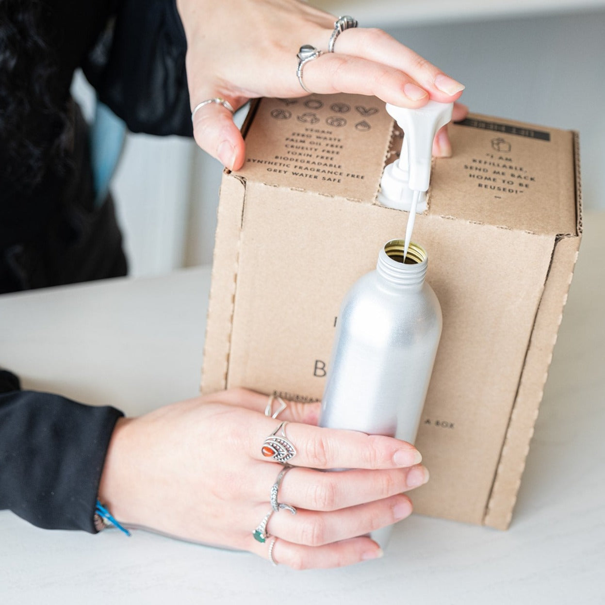 Fillaree lotion refill container with label, eco-friendly home refill for lotion, green and white packaging, minimalist design.
