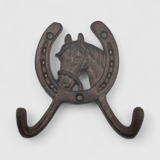Rustic cast iron horseshoe wall hook with horse head design from Iron & Blossom, ideal for home decor and coat or key hanging.