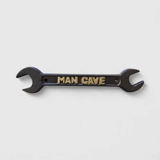 Iron & Blossom cast iron spanner wrench man cave plaque featuring rugged industrial decor with a vintage wrench design.