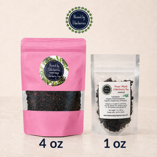 Blessed by Elderberries Power Blend Elderberry Tea in a clear glass cup with fresh elderberries and tea leaves.