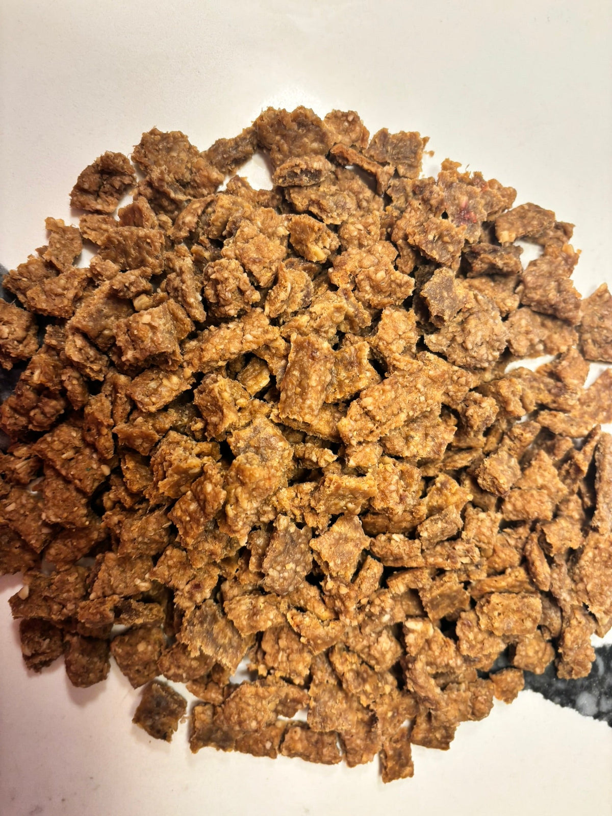 Organic beef training treats for dogs from PAWsitively Organic Dog Bakery, showing small, high-value dog training bites in a bag.