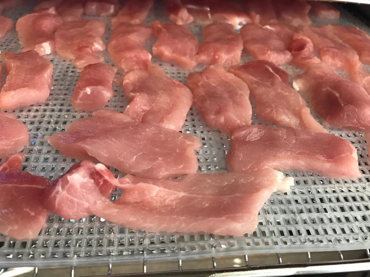 Dehydrated pork loin dog treats from Bear's Bites, single-ingredient, natural dog treats with visible pork loin pieces.