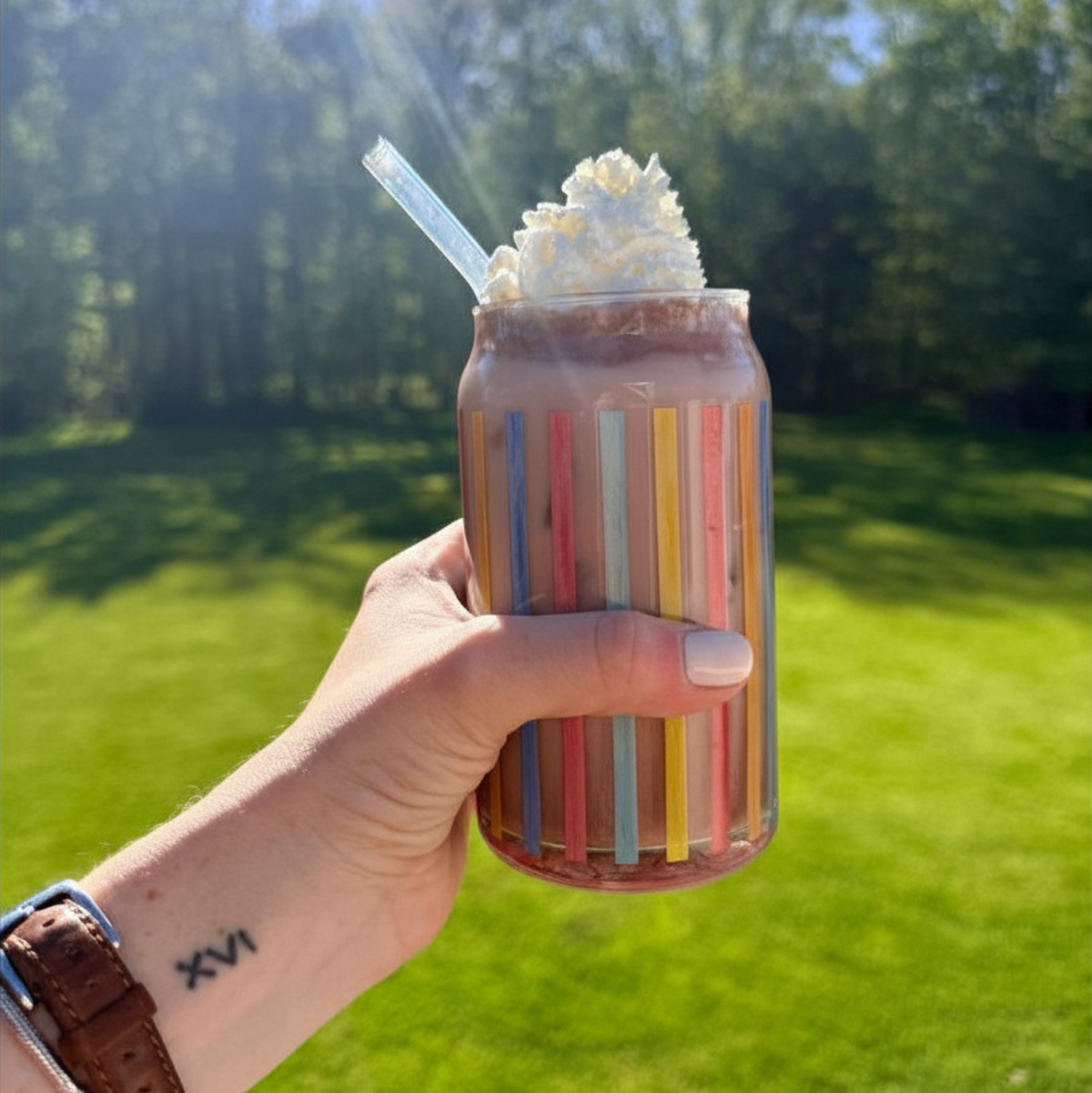 Iced salted caramel cocoa drink in a clear glass, topped with whipped cream and caramel drizzle, by Fireside Coffee Co.