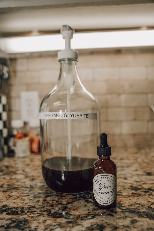 Onic Brands Elemental Oregano Glycerite Tincture bottle with dropper cap, labeled with oregano and herbal ingredients.