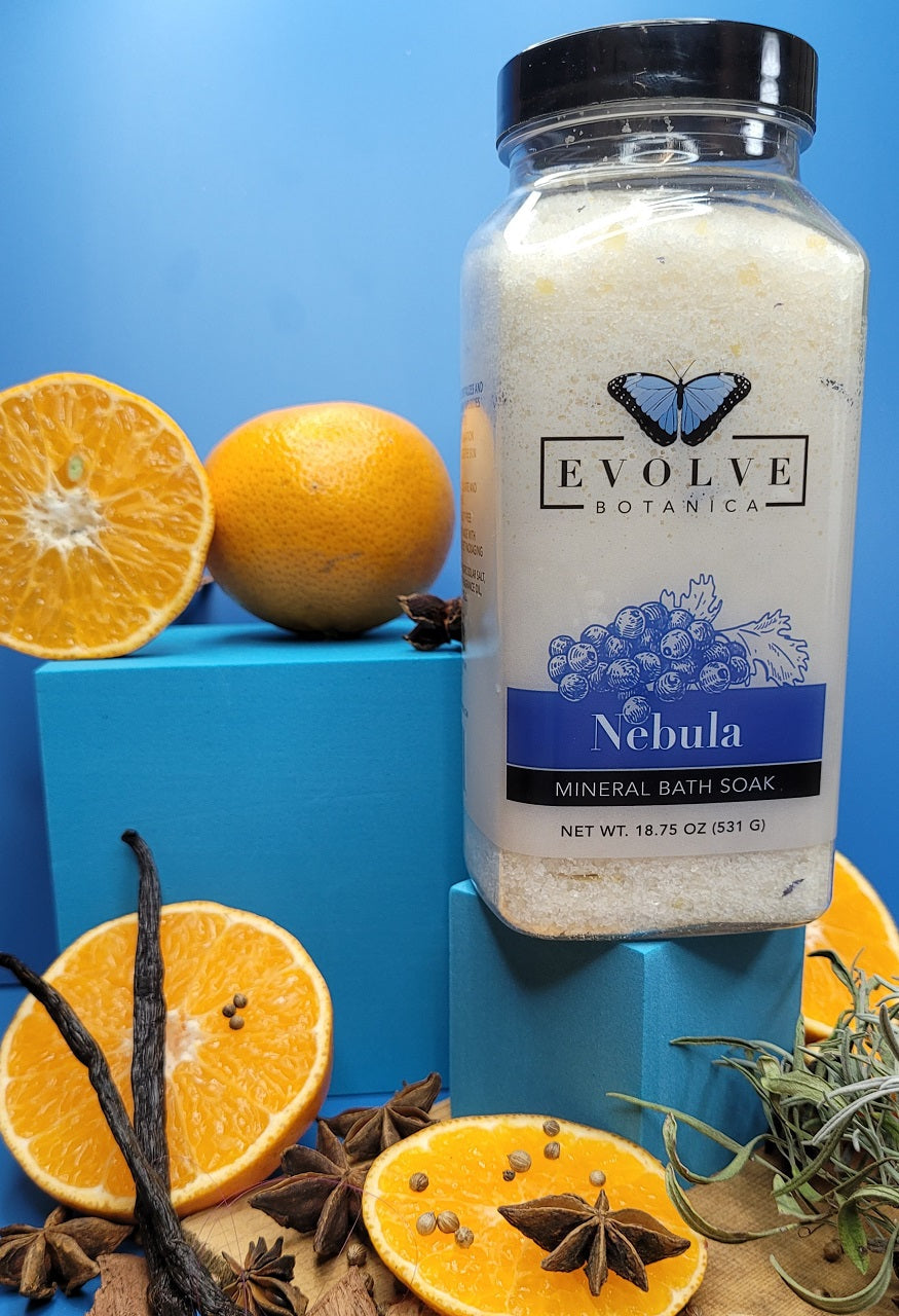 Evolve Botanica Mineral Soak Nebula bath salt in a clear jar with colorful crystals, ideal for relaxing bath experiences.
