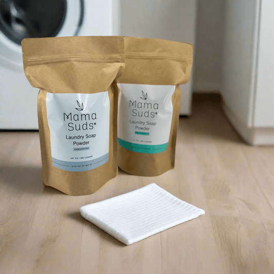 MamaSuds laundry soap powder in a white container with a green label for household cleaning.