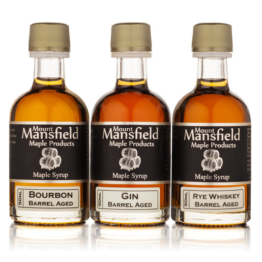Three bottles of barrel-aged Vermont maple syrup from Mount Mansfield Maple Products in a sampler set.