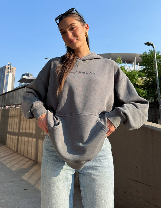 Unisex hoodie by Elevated Faith featuring "Not Sorry Jesus Is King" printed design, comfortable casual wear.
