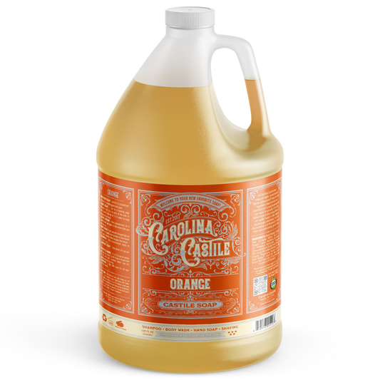 Orange Carolina Castile Soap gallon jug with vibrant orange liquid soap in a clear container.