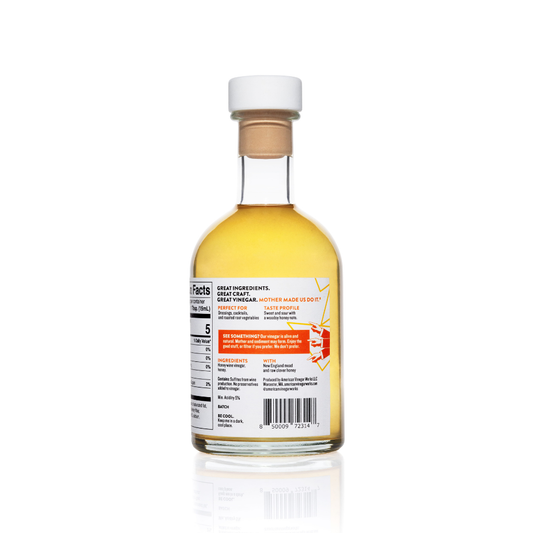 American Vinegar Works original honey wine vinegar bottle, showing the label and clear glass container on a neutral background.