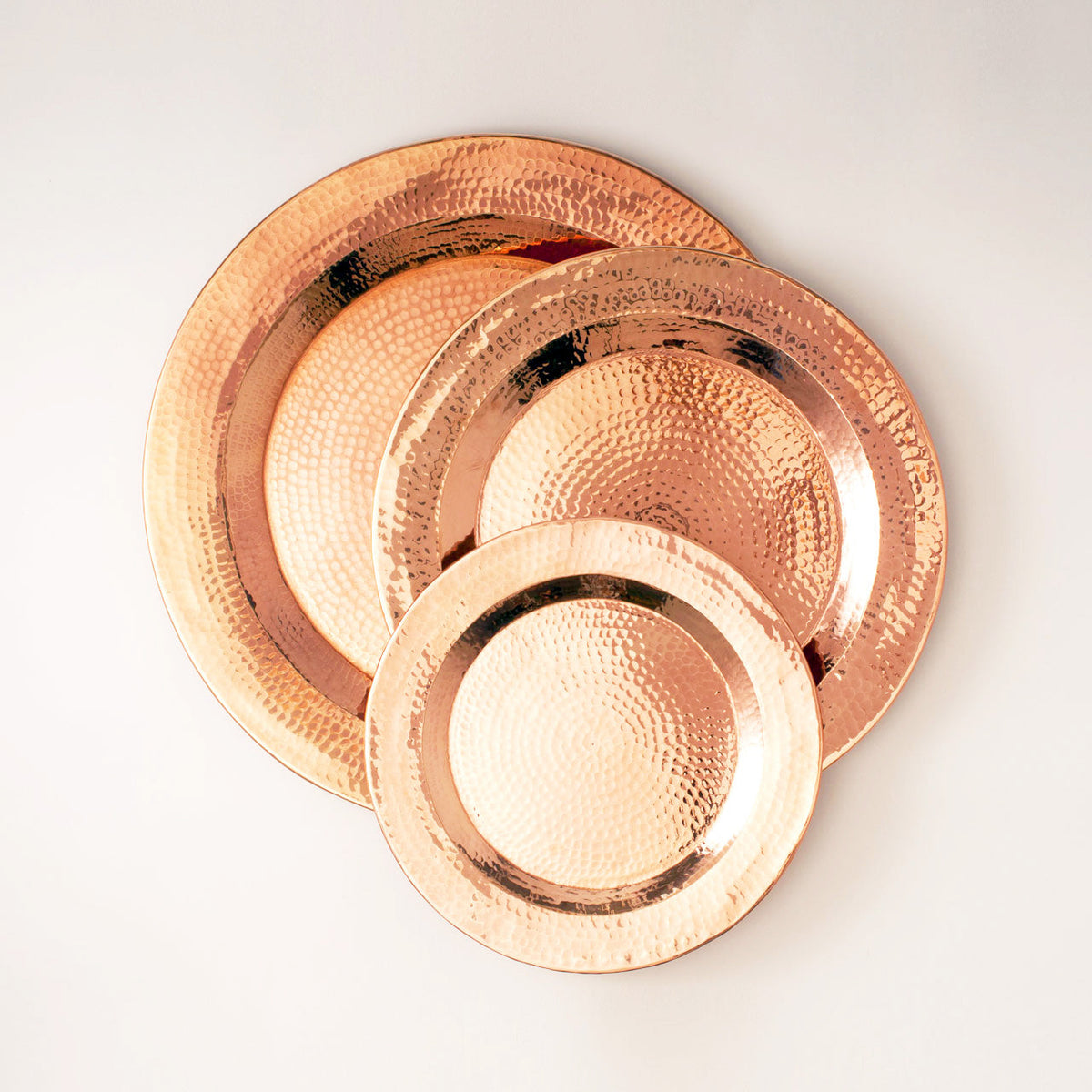 Set of Sertodo Copper Thessaly round platters with a sleek, polished finish, perfect for serving food in elegant style.