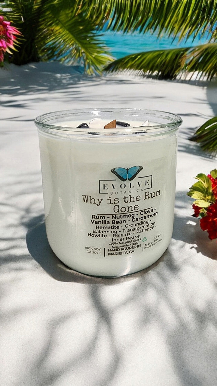 Evolve Botanica Rocks Candle "Why Is The Rum Gone?" with hematite and howlite stones, featuring a wood wick for grounding and relaxation.