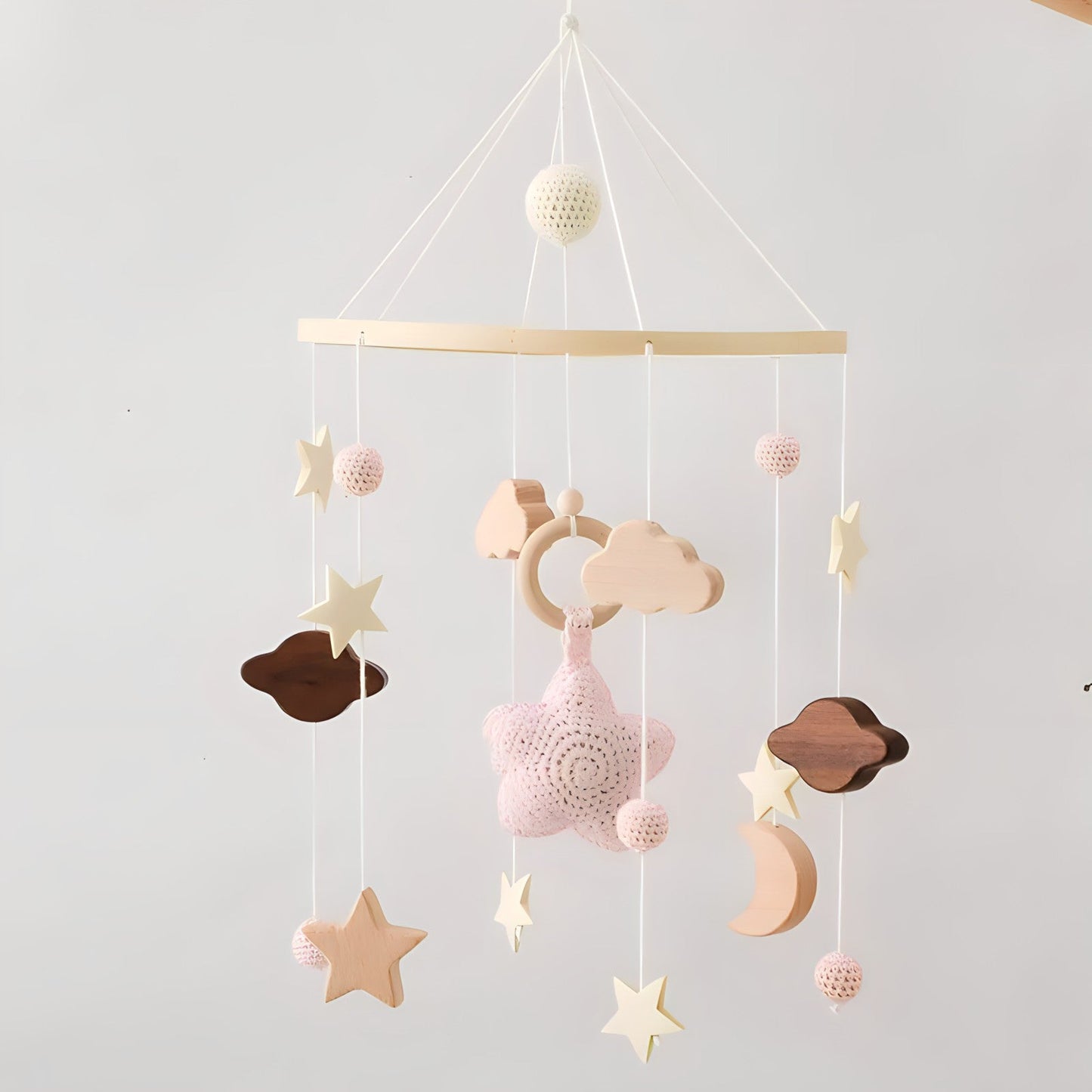 Wooden mobile hanging toys by Petite Pioneers, featuring colorful, handcrafted wooden animals and shapes for babies.