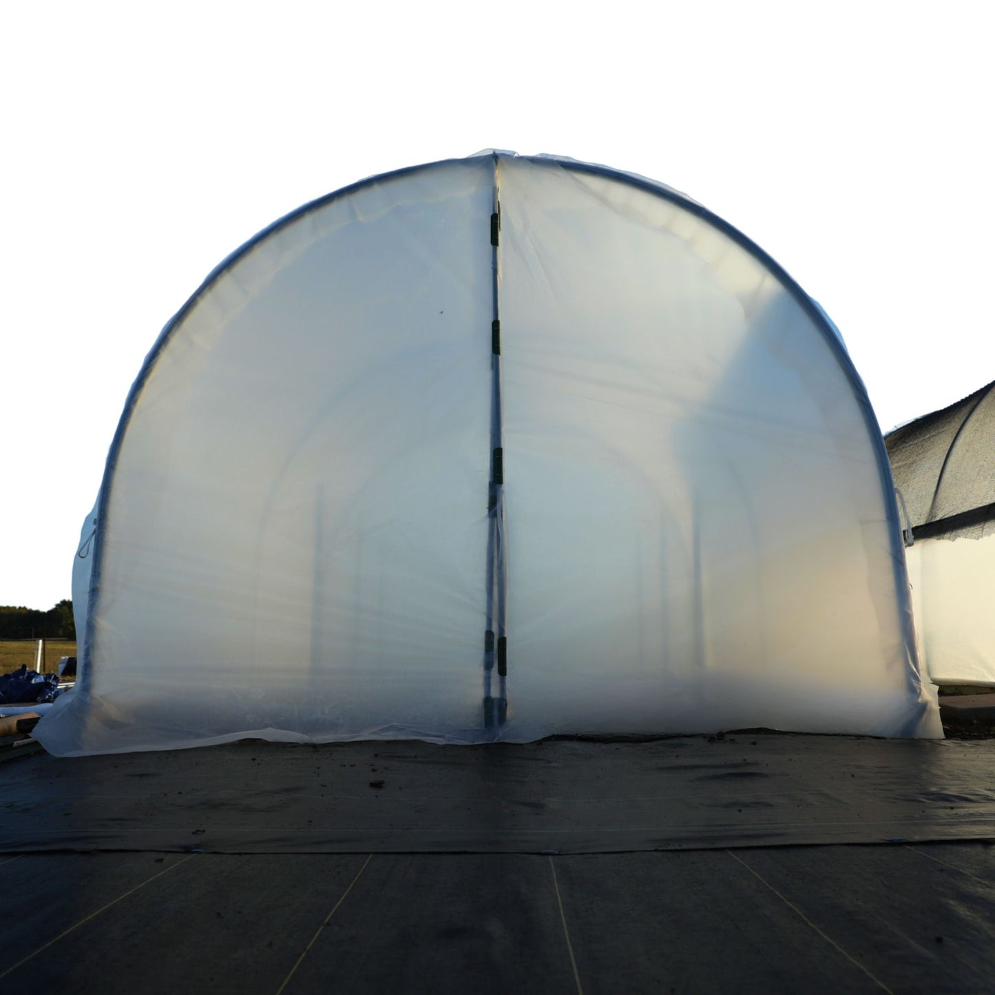 Closed scissor door kit for hobby greenhouse, by Bootstrap Farmer, showing sturdy metal frame and hinge mechanism.