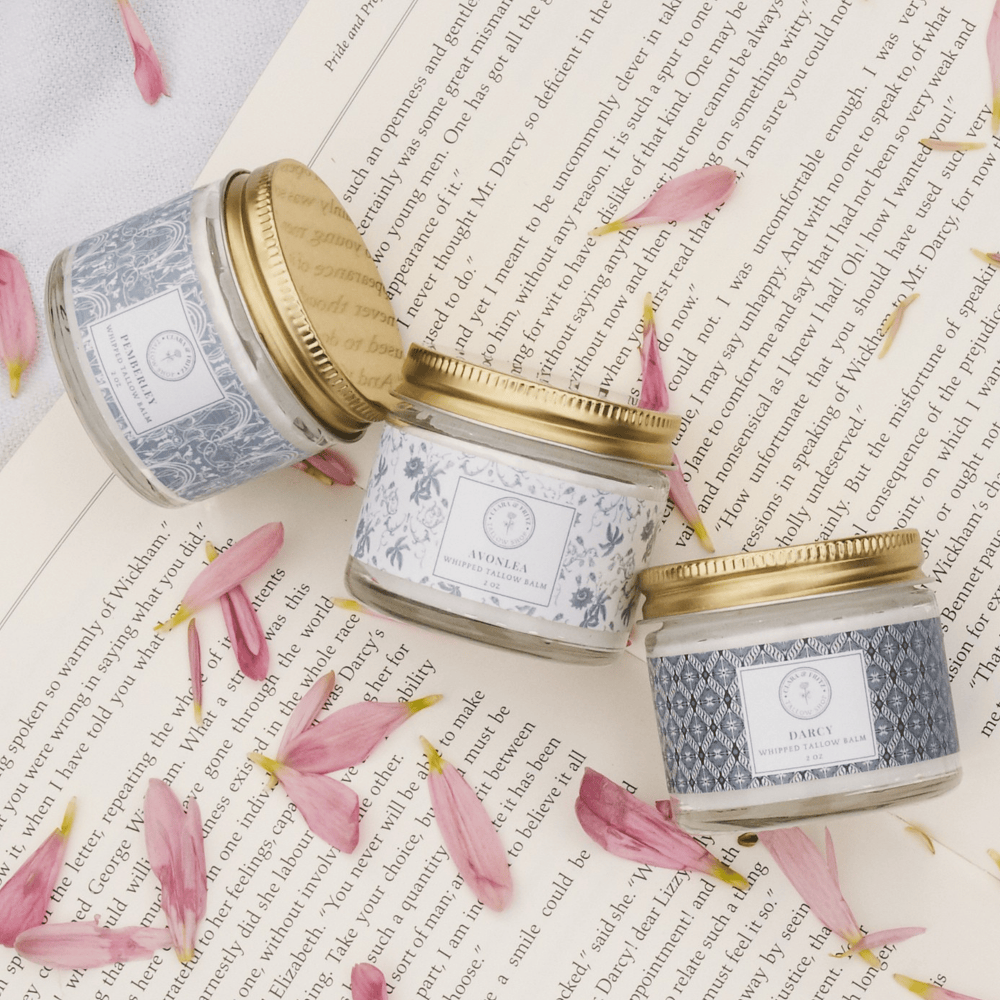 Clara & Fritz Tallow Shop Signature Scent Trio featuring three lotion and moisturizer bottles with elegant packaging.