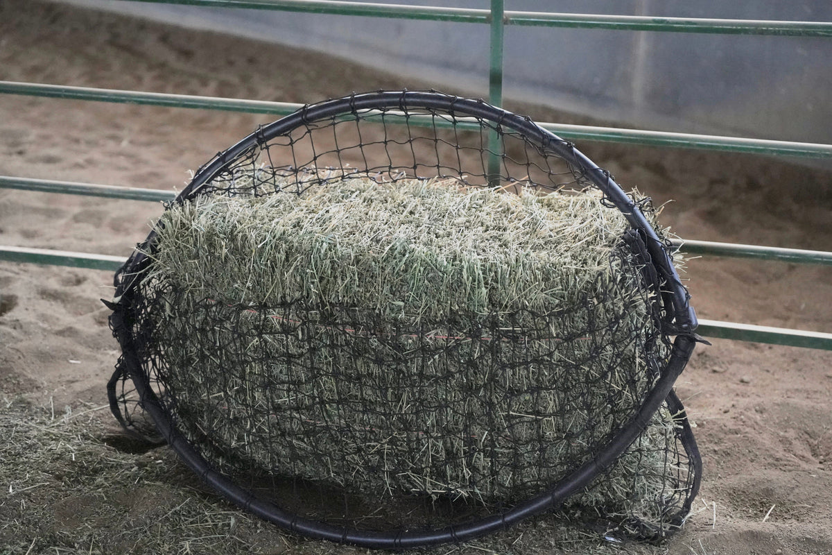 Square bale net by Haylo Haynets, LLC, showing the net opening around a square hay bale for secure feeding.