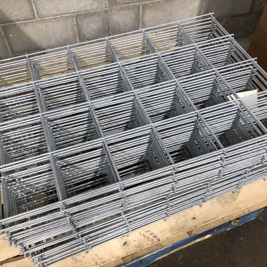 Stack of Bootstrap Farmer galvanized wire panels, durable metal fencing for gardening and agricultural use.
