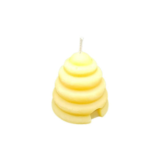 Small beeswax candle in a natural 2 oz container, highlighting its warm beeswax texture and artisanal design.