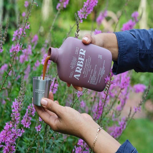 Organic Bio Fungicide by Arber, showing a container of natural plant protection product with fresh green leaves in the background.