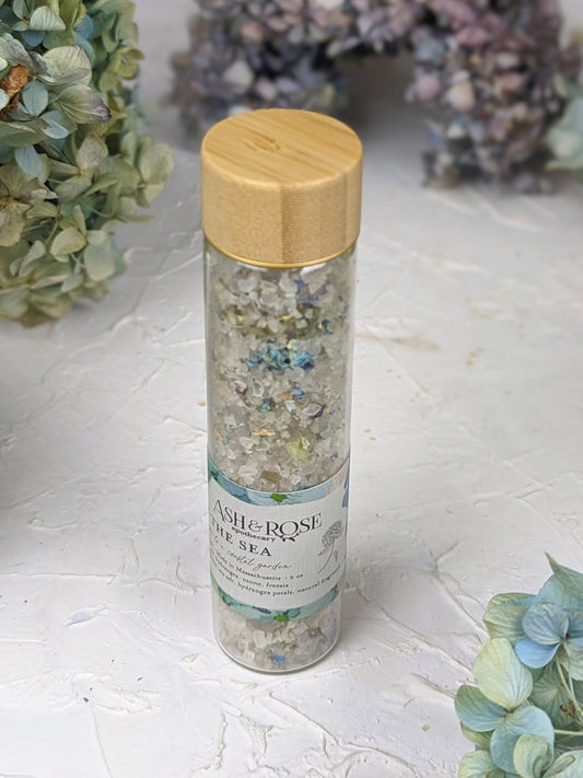 Ash & Rose By The Sea bath soak vial with calming sea-inspired ingredients in a clear glass vial, perfect for relaxing baths.