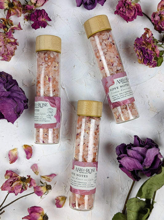 Ash & Rose Love Notes Bath Soak vial with floral and herbal ingredients for a relaxing bath experience.