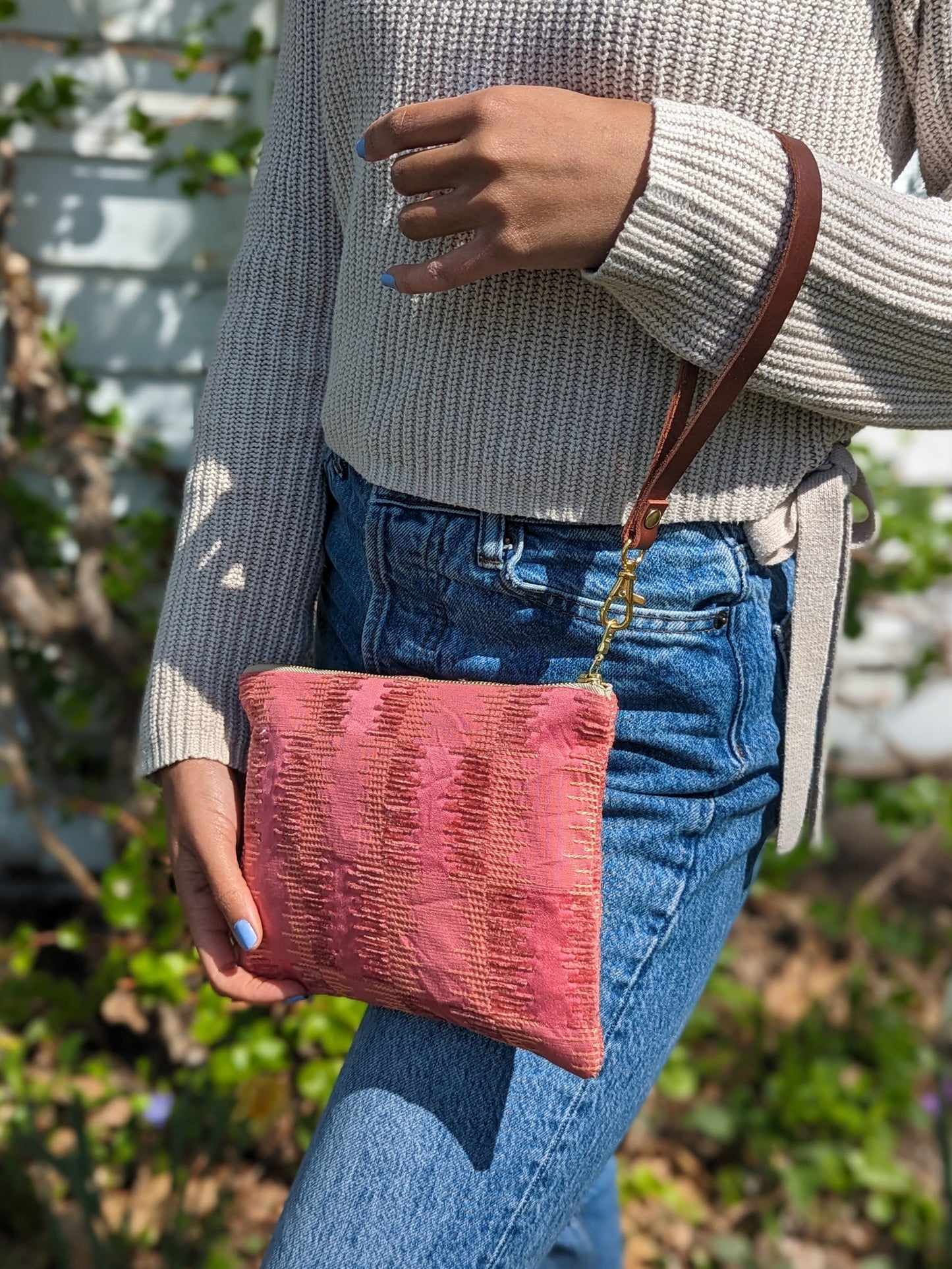 Ash & Rose Shades of Apricot wristlet purse with textured fabric and gold-tone zipper, stylish and compact accessory.