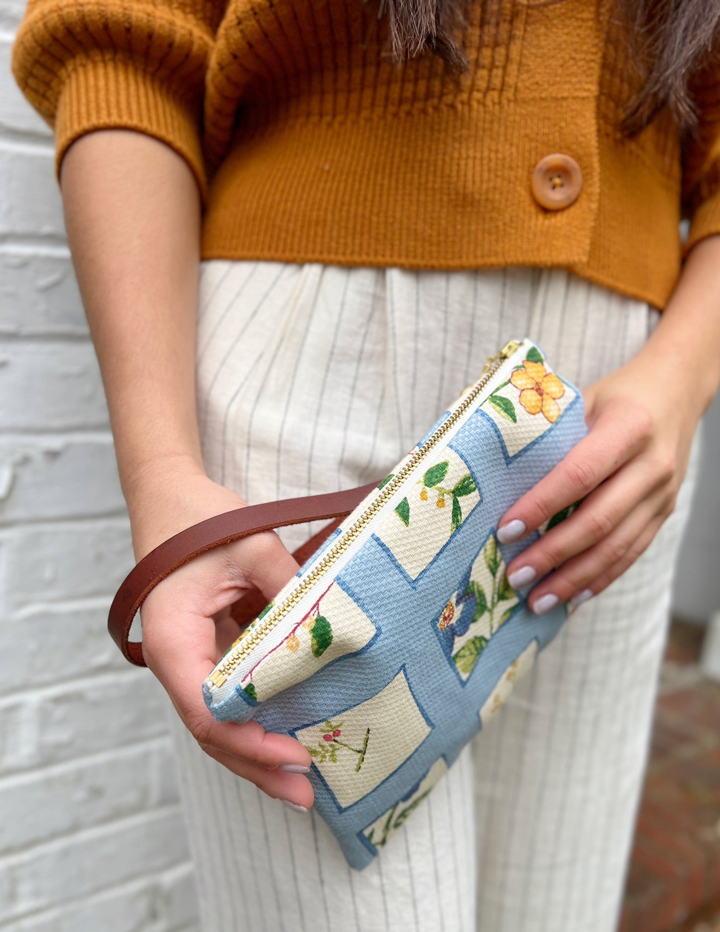 Ash & Rose Summer Meadow wristlet purse featuring floral print, compact design, and wrist strap for easy carrying.