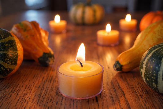 Set of Bluecorn Candles pure beeswax tea light candles in clear poly cups, perfect for fall decor and Thanksgiving hosting.