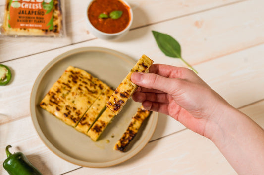 Baked cheese snack with jalapeño peppers from Cheese Brothers, Inc., showcasing golden baked cheese pieces with spicy jalapeño bits.