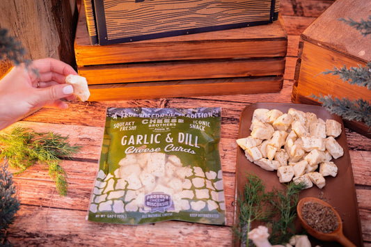 Garlic and dill cheese curds from Cheese Brothers, Inc., fresh and ready to enjoy, shown in a resealable pack.