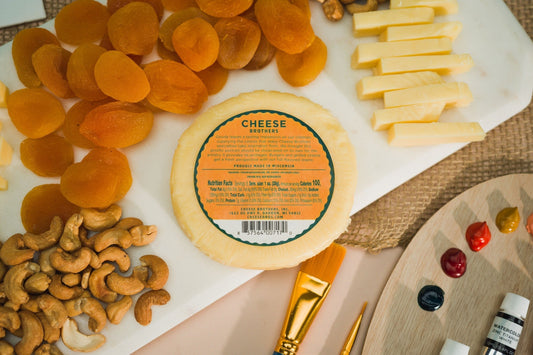 Creamy classic Gouda cheese by Cheese Brothers, Inc., with its smooth, golden surface and rich, firm texture.