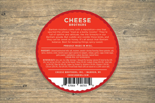 Slice of Honey Sriracha Gouda cheese by Cheese Brothers, Inc. with a smooth, creamy texture and a sweet-spicy flavor profile.