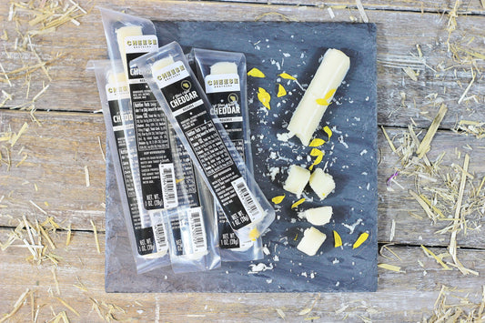 Cheese Brothers Inc. 8-year aged cheddar snack sticks, 30-pack, showing crispy cheese sticks in a clear container.