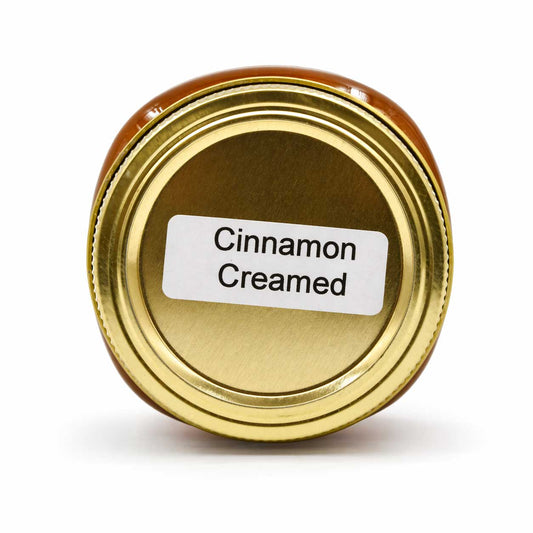 Creamed honey with cinnamon from Lance Honey Farms, 12 oz jar, showcasing smooth, creamy texture with cinnamon swirl visible.