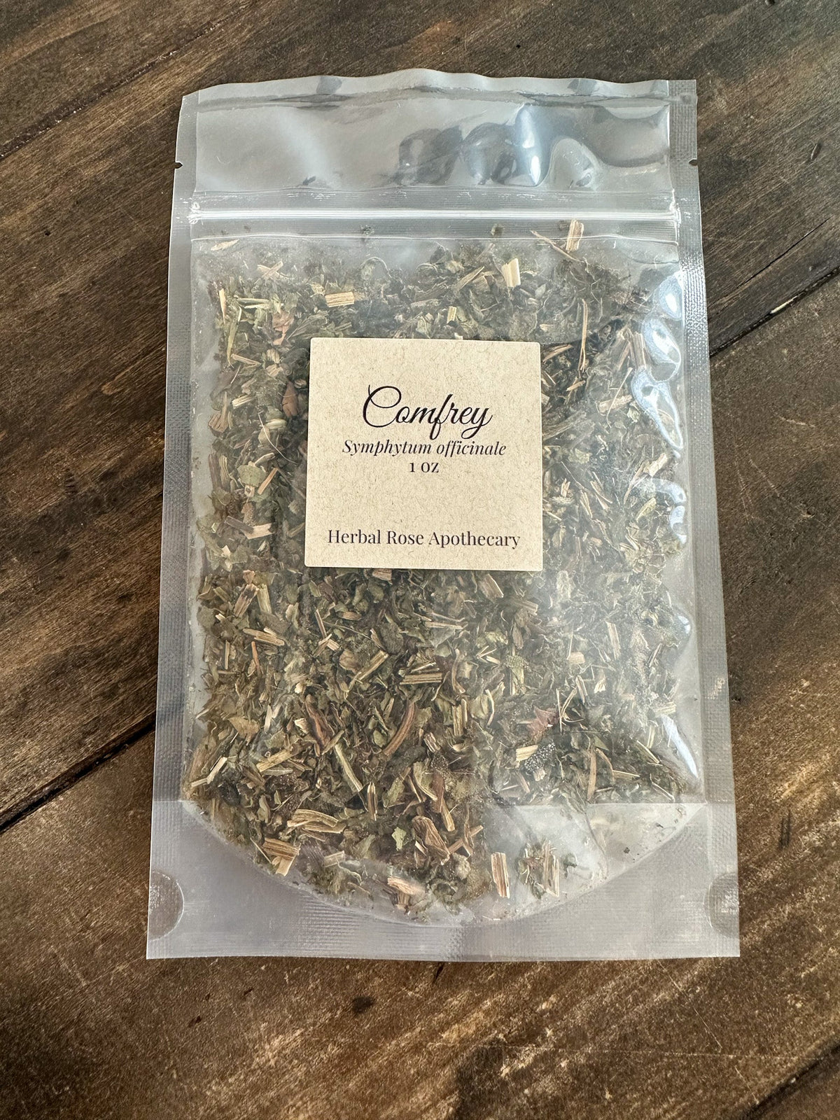 Dried comfrey herb in a 1oz package from HerbalRoseApothecary, showing green leafy herbs suitable for herbal remedies.