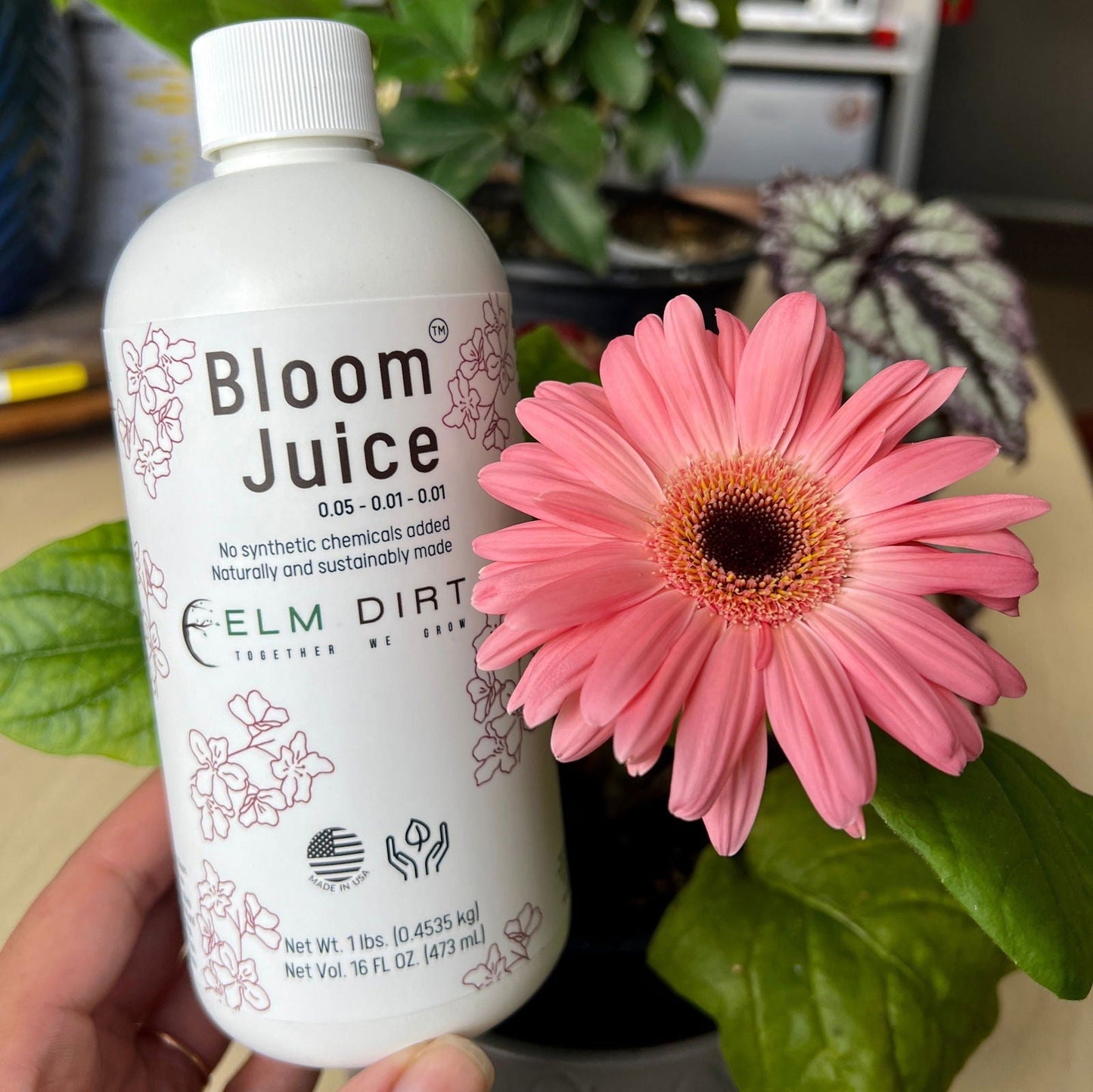 Elm Dirt Bloom Juice fertilizer bottles, 32 oz each, showcasing the natural plant nutrient formula for healthy garden growth.