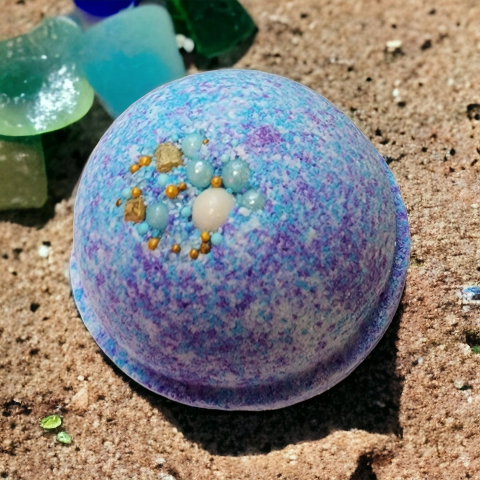 Evolve Botanica Sea Glass Bath Bomb with blue and green hues, designed for a relaxing bath experience.