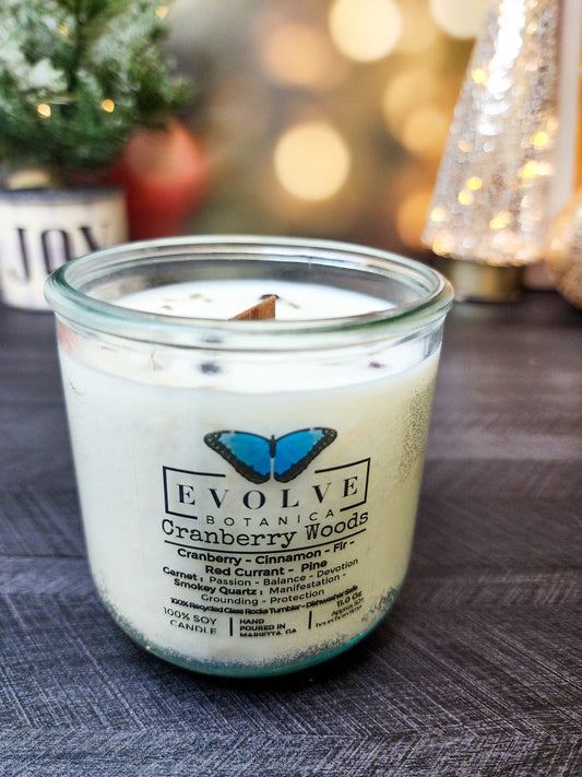 Evolve Botanica Cranberry Woods Rocks Candle with wood wick, garnet, and smokey quartz gemstones in a soy candle jar.