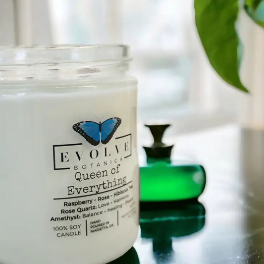 Evolve Botanica 9oz jam jar soy candle with rose quartz and amethyst crystals, natural wood wick, titled Queen of Everything.