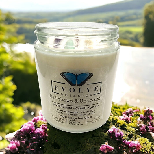 Classic 9oz jam jar soy candle with rainbows, unicorns, and fluorite crystal accents by Evolve Botanica.