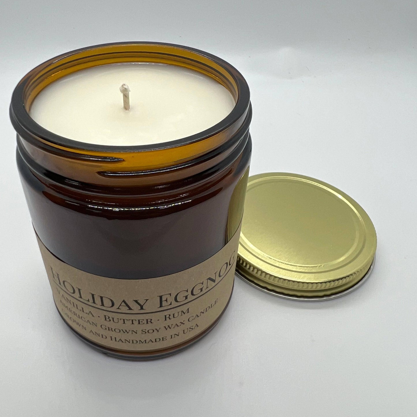 Soy wax candle in a 9 oz amber apothecary jar with holiday eggnog scent, by Prairie Fire Tallow, Candles, and Lavender.