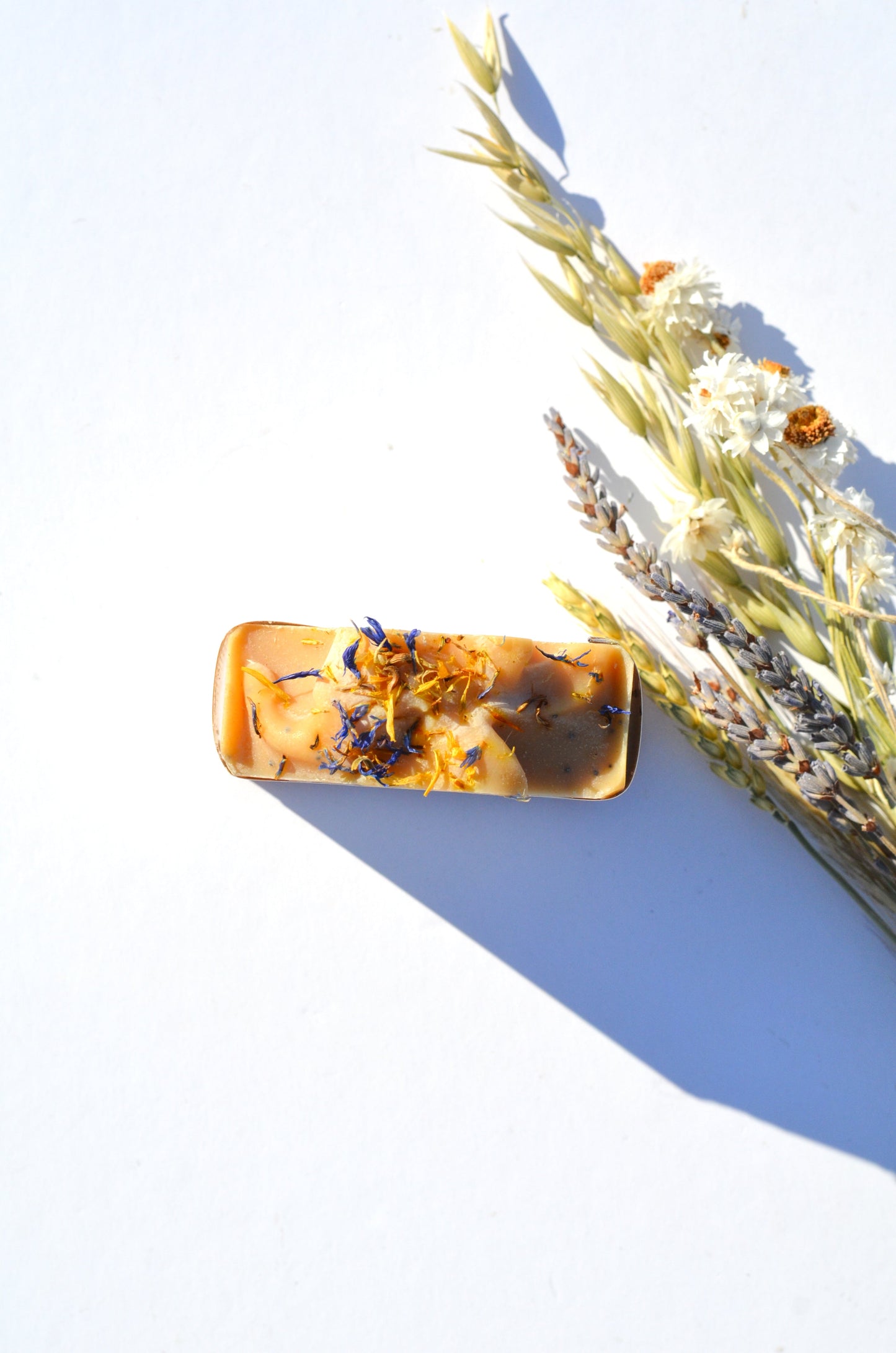 Handmade Lemon, Honey, and Poppy Seed Goat Milk and Tallow Soap Bar by Pretty Farm Girl with visible ingredients and textured soap surface.