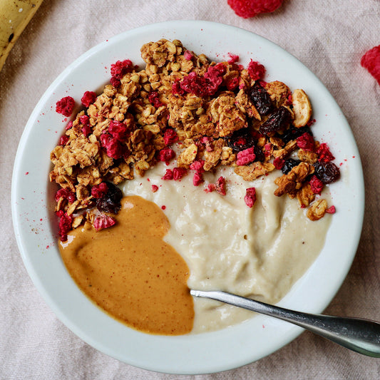 Canned Rooted Living Peanut Butter Crunch Granola in a can with a label featuring oats, peanuts, and a crunchy texture.