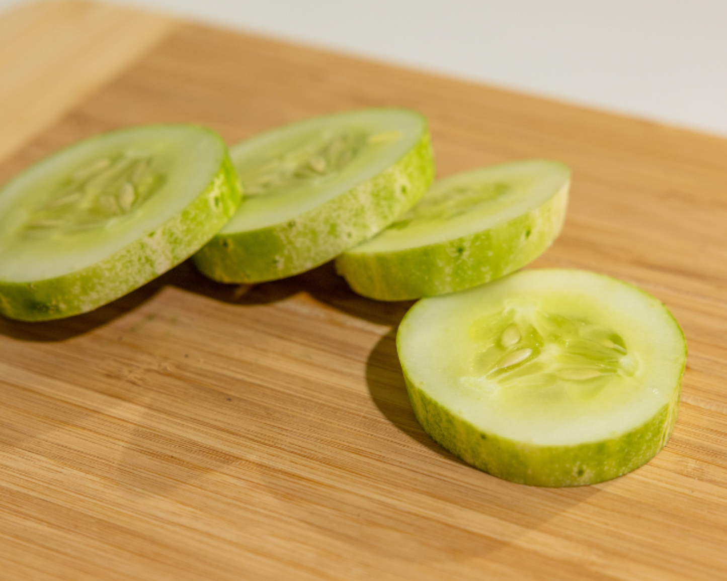 Packet of Pick-A-Bushel Hybrid Cucumber Seeds from Seeds 'n Such, showing 25 seed packets for planting cucumbers.